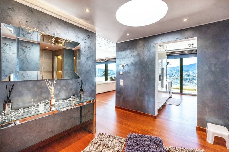 modern interior, large mirror, glass table, wooden floor, gray walls, city view