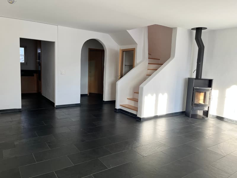 empty room, black tiles, white walls, wooden stairs, fireplace