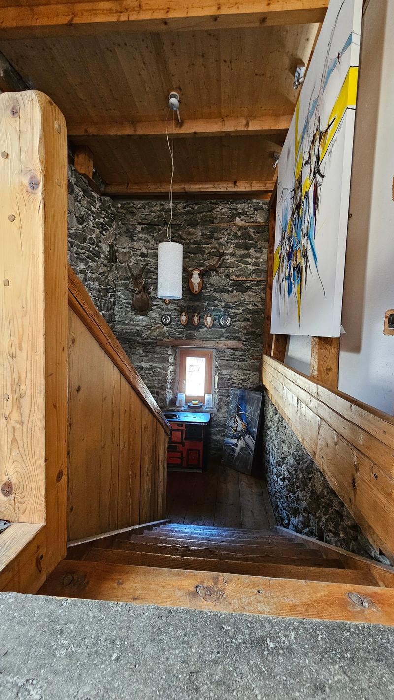 staircase with wooden railings and stone wall, lamp, wooden flooring