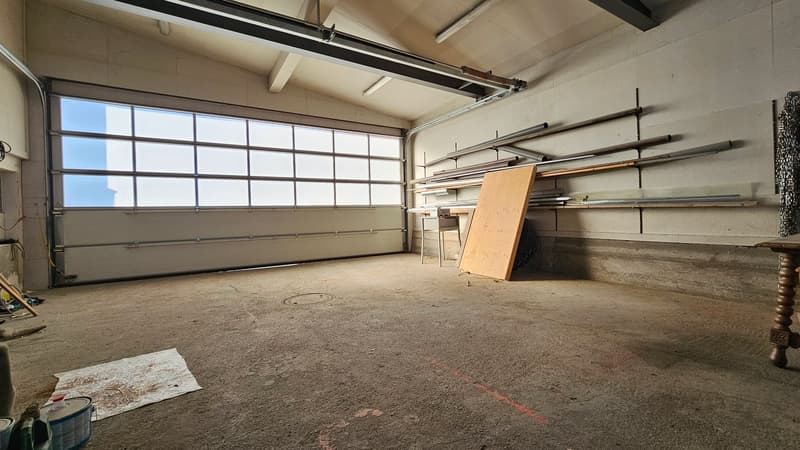 large window, concrete floor, metal racks, wooden board, open door