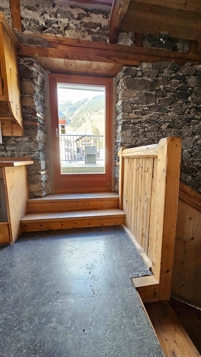 stone wall, wooden door, window, balcony, wooden railings, flooring