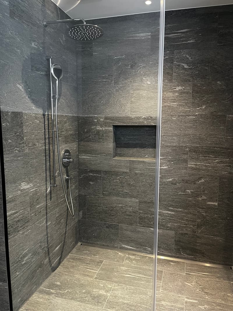 shower, showerhead, tiled walls, tiled floor, shelf, showerhead