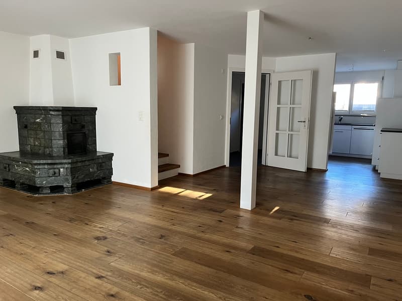 empty room, fireplace, wooden floor, white walls, open door, kitchen