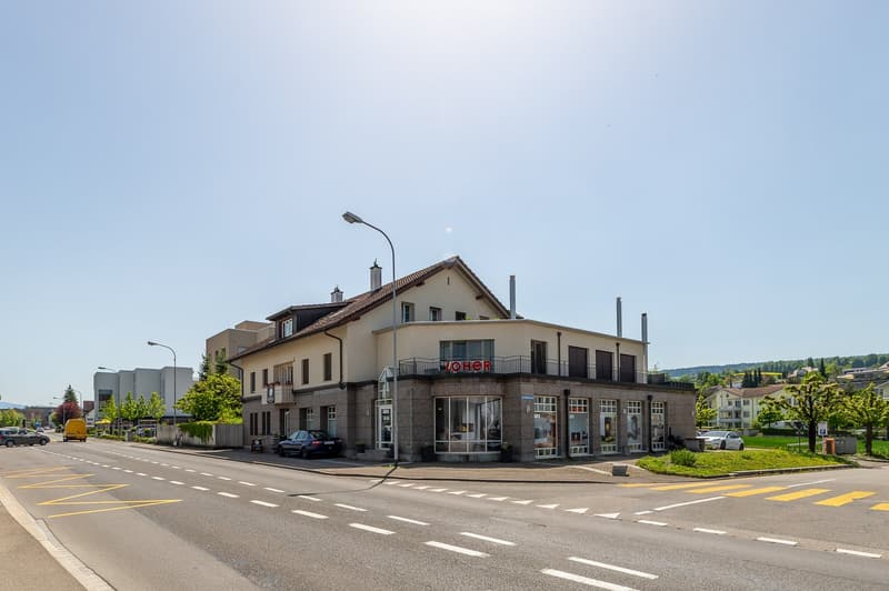 2 story house with a basement, glass windows, balconies, street lamp