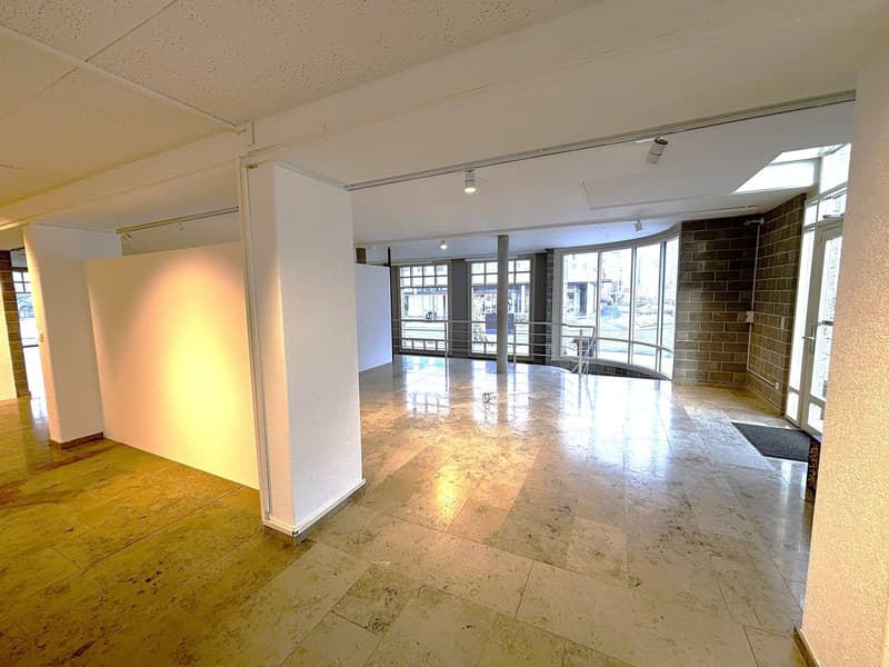 Empty room, large windows, high ceilings, tiled floor, white walls, ceiling lights