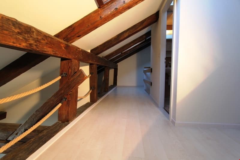wooden beams, wooden floor, rope railing, white walls