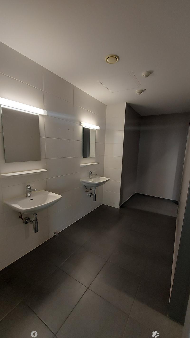 modern bathroom with white sink, silver faucet, mirror, light panel