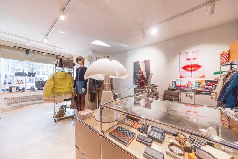 modern shop interior with glass cabinets and clothing on hangers