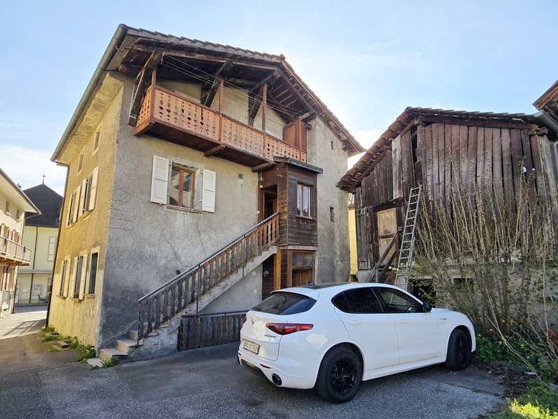 Two story building, balcony, steps, windows, nearby building