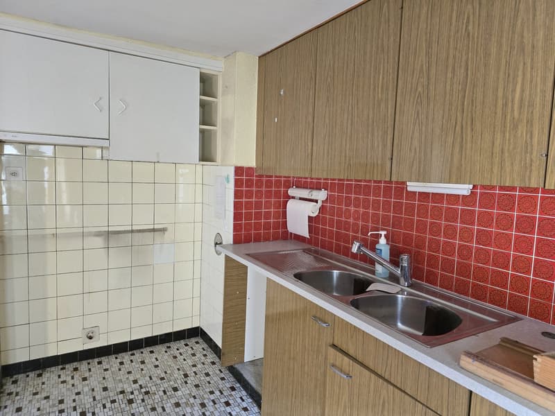 modern kitchen with wooden cabinets, tiled walls, stainless steel sink, white tiled floor, dishwasher, washing machine