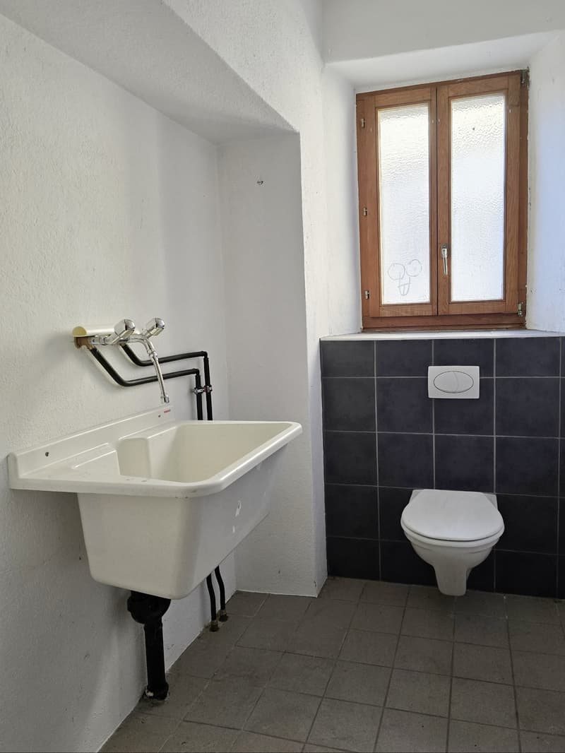 single-basin sink, white toilet, window, tiled floor, white walls