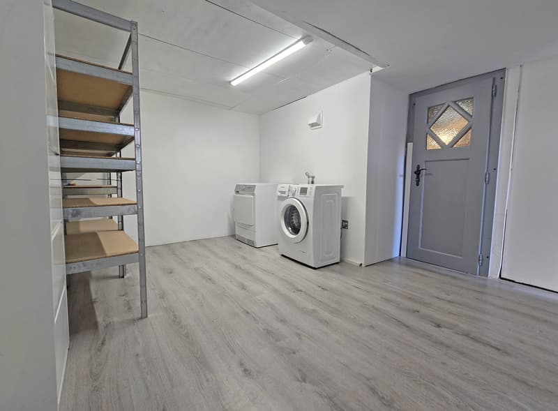Laundry room with washing machine, dryer, and storage shelves
