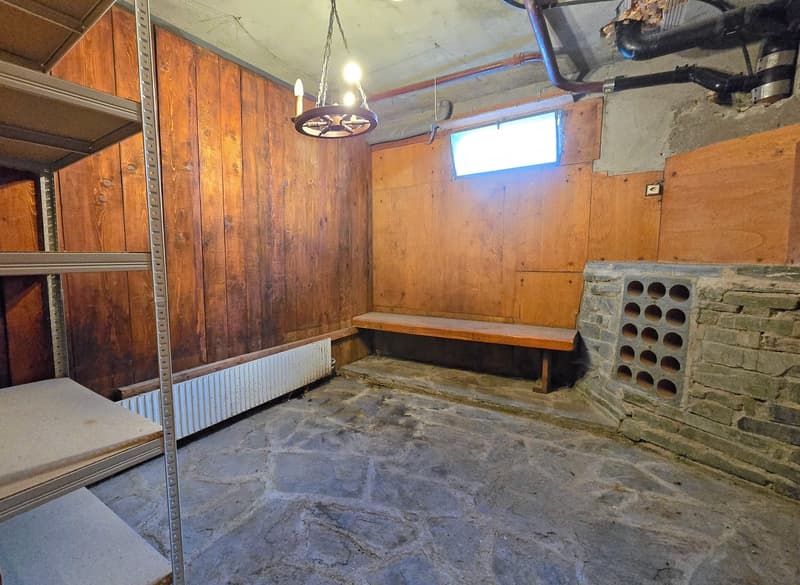 wooden walls, stone floor, bench, radiator, fireplace, window, chandelier