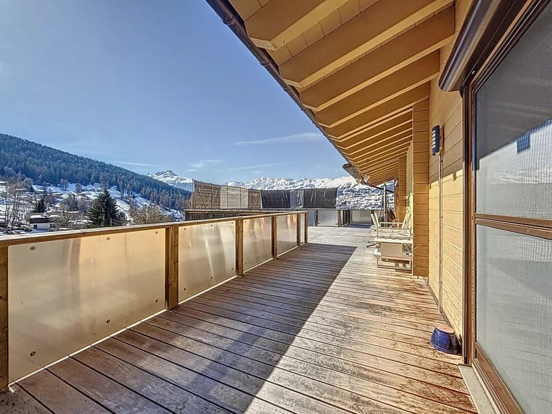 Grande terrasse lamée faisant le tour du chalet avec vue panoramique