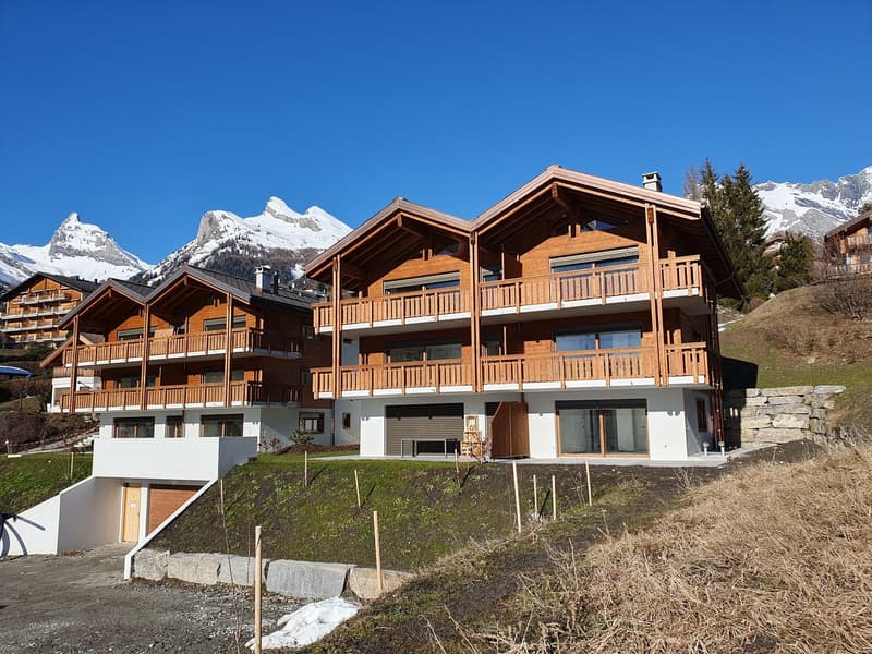 2 story ski chalet, wood exterior, raised ground floor, balconies
