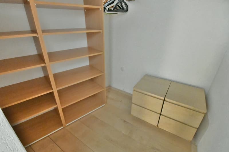 wooden shelves, wooden floor, drawers, empty room