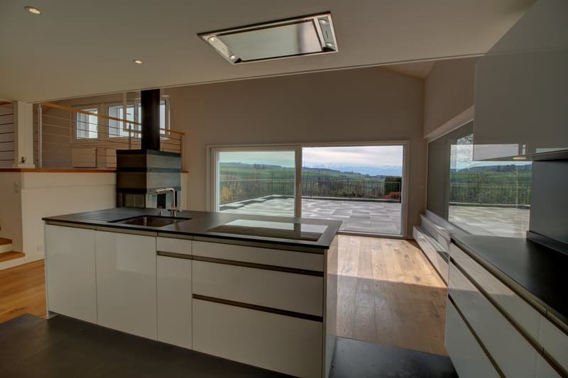 kitchen with open plan to living room, windows, balcony with railing, country landscape view