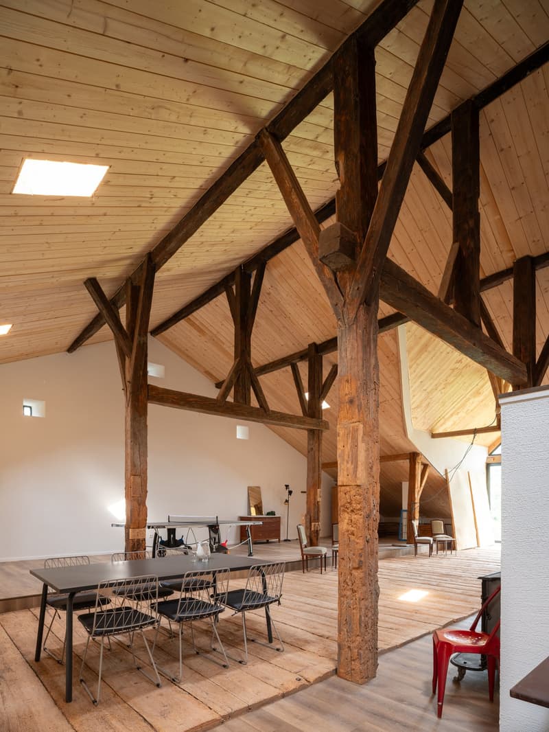 exposed wooden beams, wooden floor, dining table with chairs, indoor tables and chairs