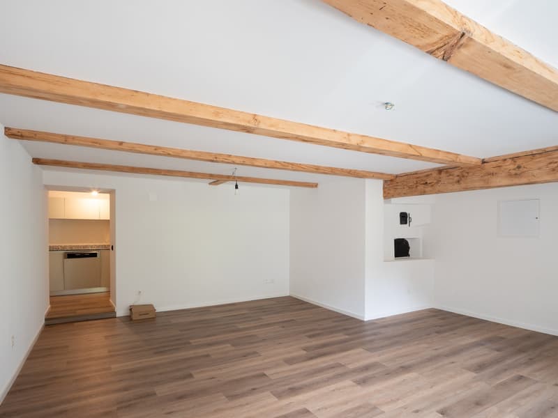 empty room, hardwood floors, white walls, wooden beams, open doorway