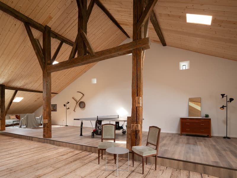 open floor plan, wooden beams, wooden flooring, dining table, chairs, ping pong table, furniture, lamps, wooden cabinet, mirror