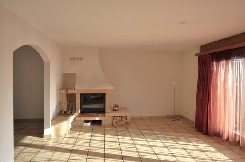 Fireplace, tiled floor, white walls, wooden storage for logs