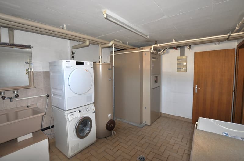 washer and dryer on top of each other, sink, water heater, metal pipes