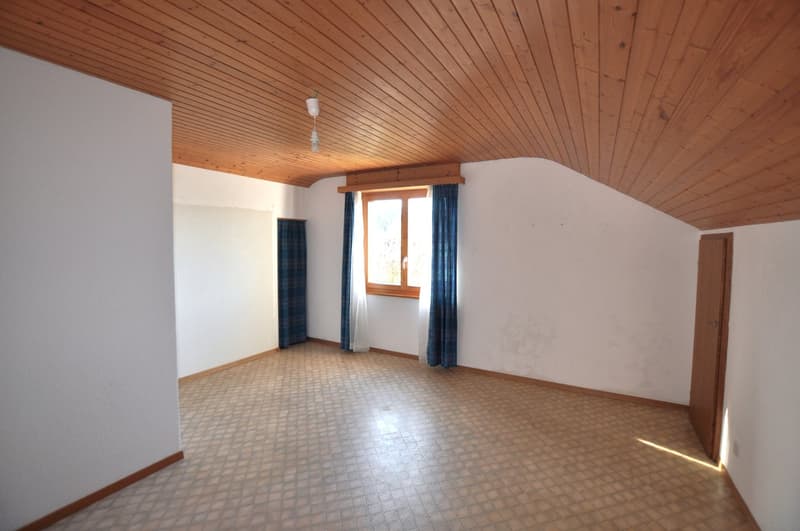 Empty room with white walls, wooden ceiling, beige tiled floor, white and blue curtains, window with wooden frame