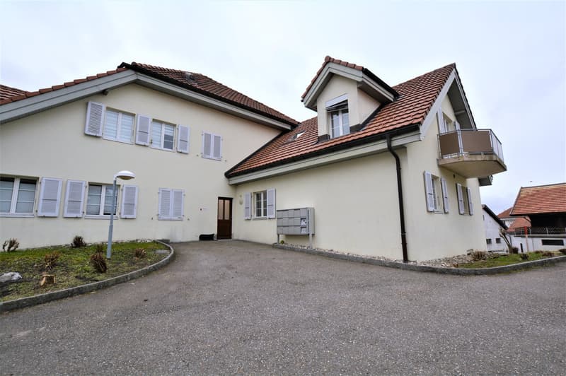 2 story house, terracotta roof, white shutters, balcony, paved driveway, mail boxes
