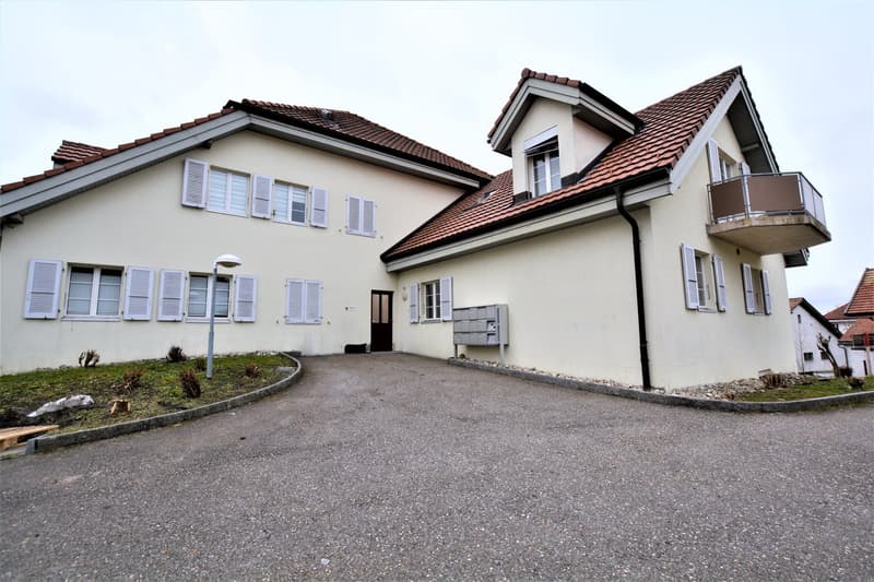 2 story house, white exterior, red roof, many windows, balcony, entrance with mailbox, street light