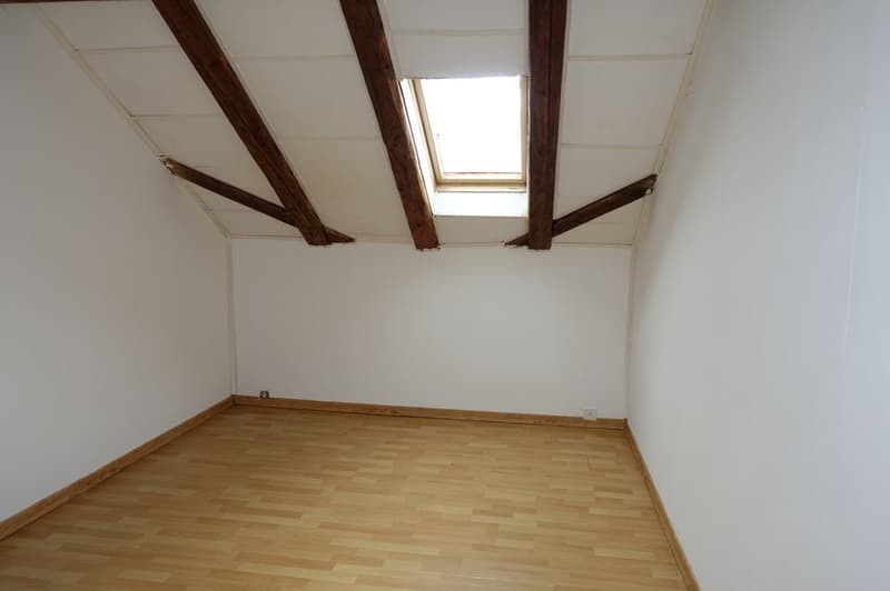 empty room, wooden floor, white walls, wooden beams, skylight