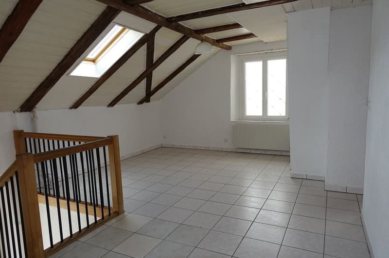 empty room, white walls, wooden ceiling, white tiled floor, wooden railing, window, skylight