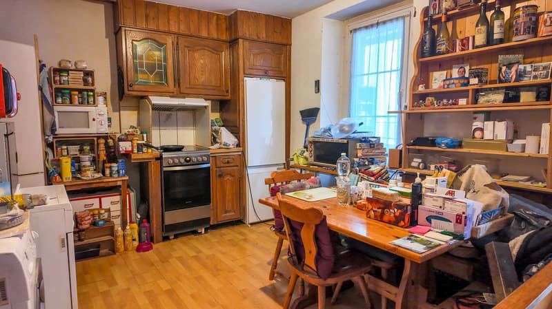 kitchen and dining area, gas stove, microwave, refrigerator, wooden table, wooden chairs