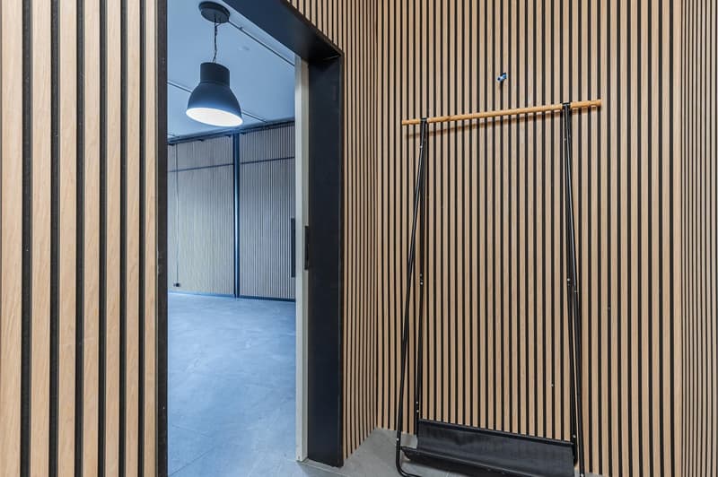 wooden wall, striped pattern, open door, hanging lamp, coat rack