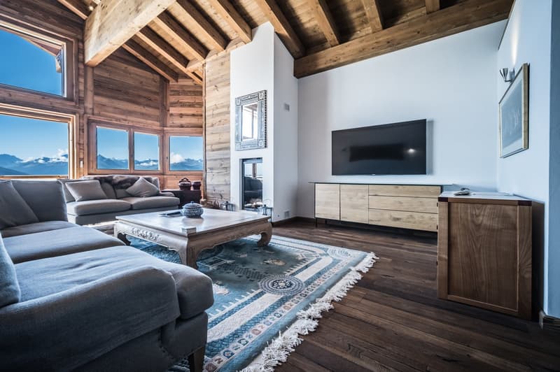 Living room with fireplace, large windows, and a view of mountains