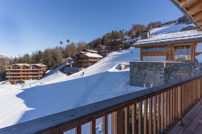 wooden balcony, snowy mountain, ski slope, gondola lift, trees, clear sky, buildings