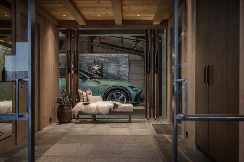interior of a garage with car, wooden ceiling, carpeted floor, glass doors, decorative bench, potted plant, picture frame