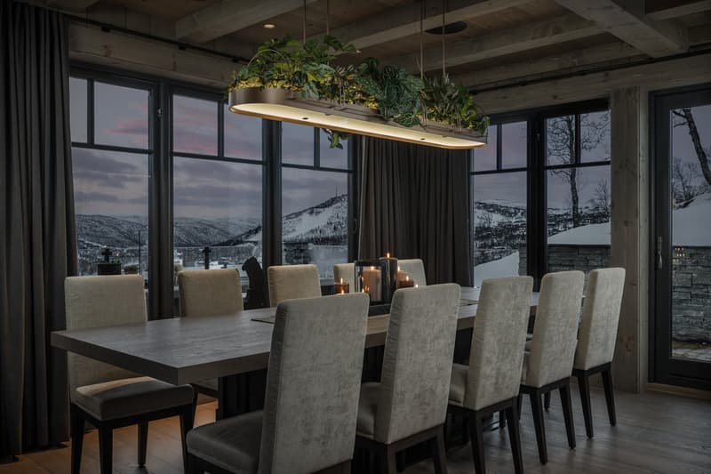 dining table with 12 chairs, modern design, floor to ceiling windows, indoor plants on ceiling