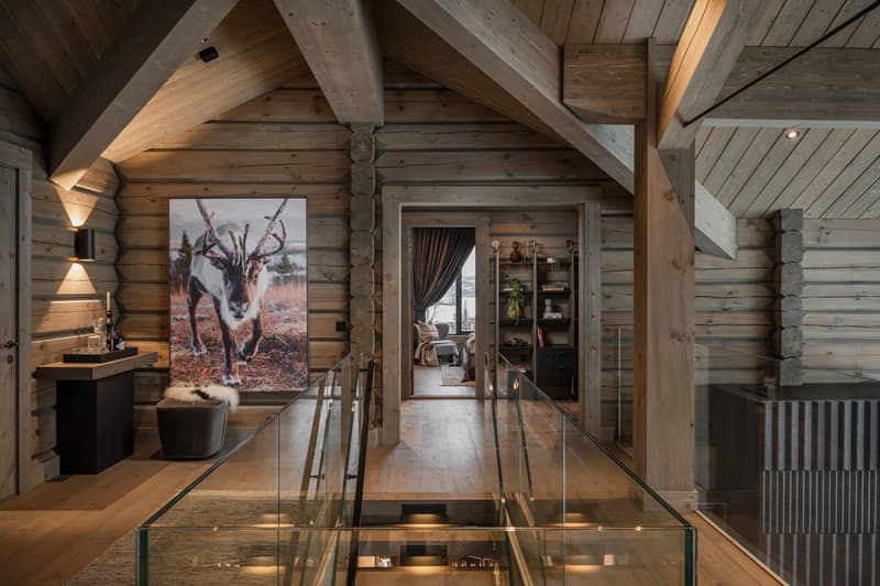 Contemporary interior with wooden wall, glass staircase, glass window, wooden floor, and glass balustrade