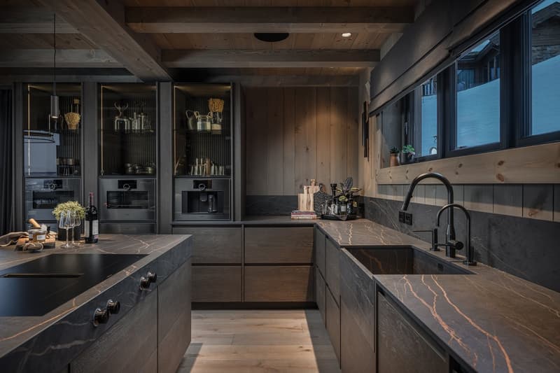marble countertops, wooden cabinets, induction cooktop, sink, wine bottles, two ovens, two coffee machines