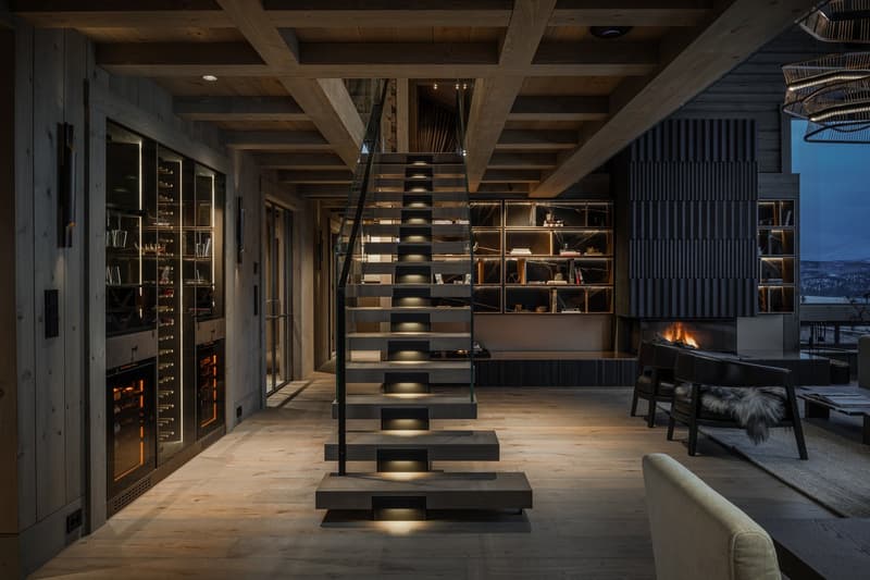 modern open-plan design, wooden interior, wide staircase, fireplace