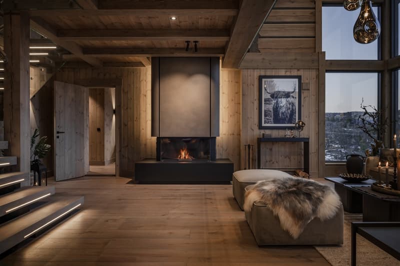fireplace, wooden walls, wooden flooring, windows, couch, table, fireplace