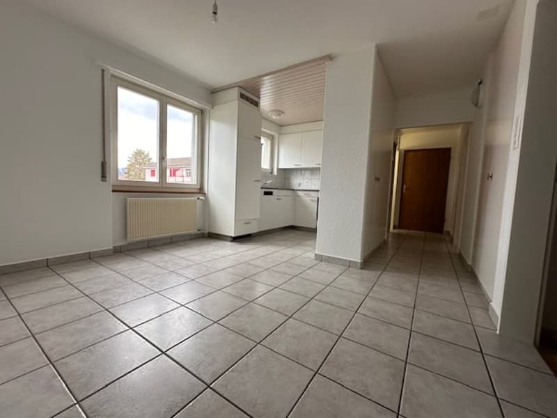 empty room, tiled floor, large window, white walls, white kitchen cabinets, ceiling lamp