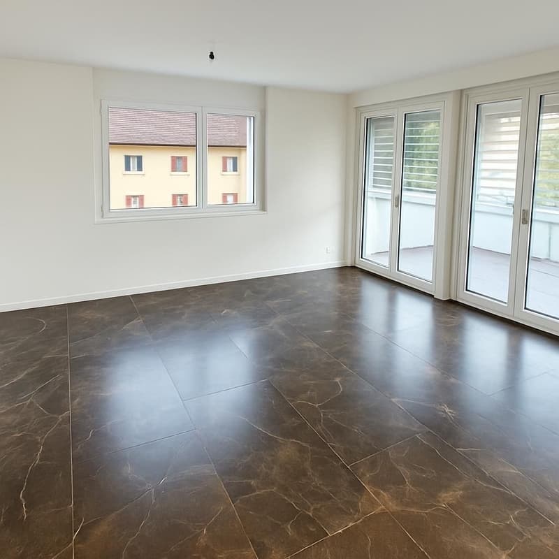 empty room with large balcony, tiled floor, sliding doors, large window