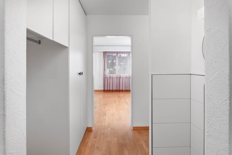 Minimalist interior, hallway, wooden floors, white walls, window with curtains, hallway leading to another room