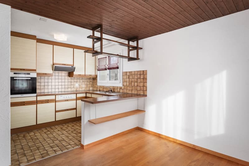 modern kitchen with oak cabinets, wooden floor, built-in oven and stove, kitchen island, sink, tiles