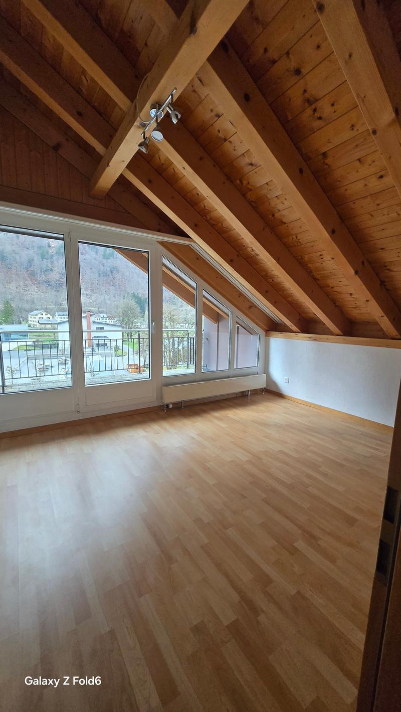 wooden ceiling, wooden floor, large windows, balcony, view of the mountains