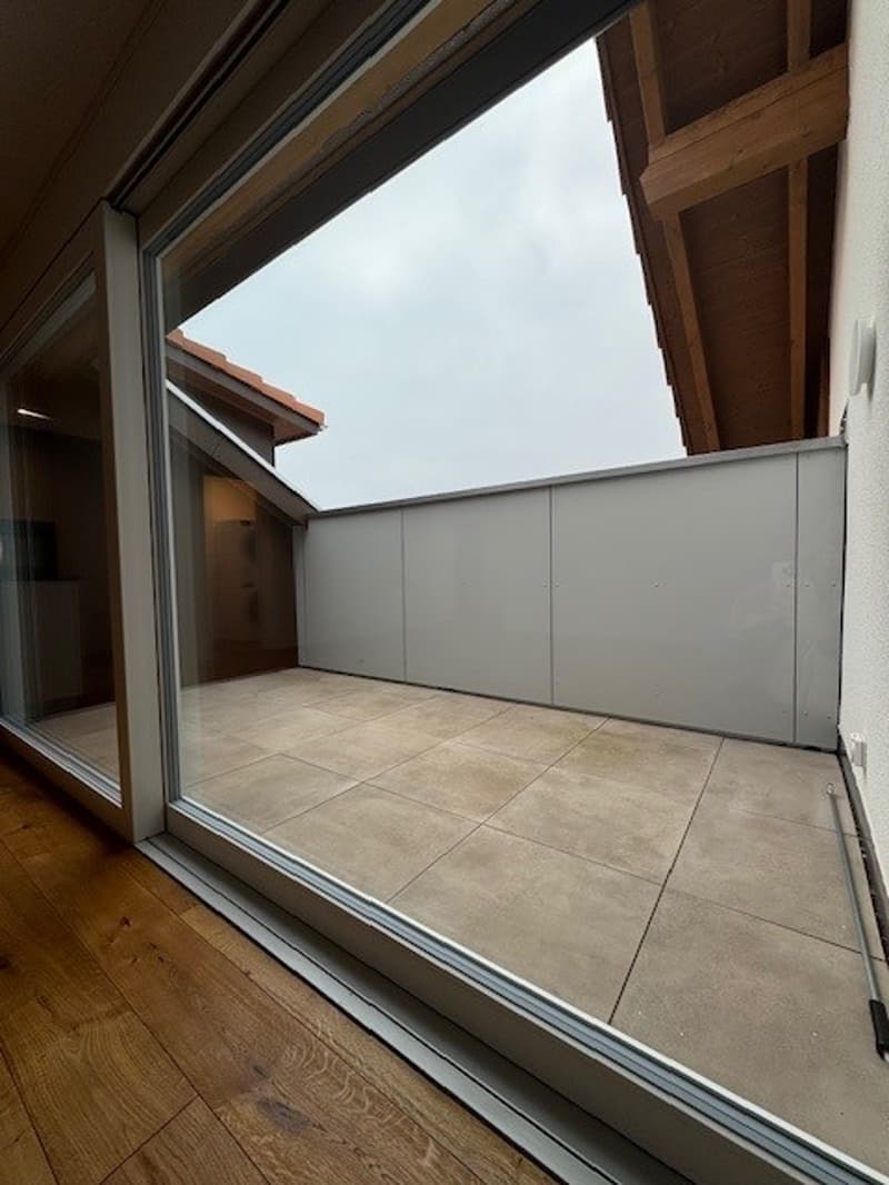 Open sliding glass doors, tiled floor, large windows, wooden ceiling