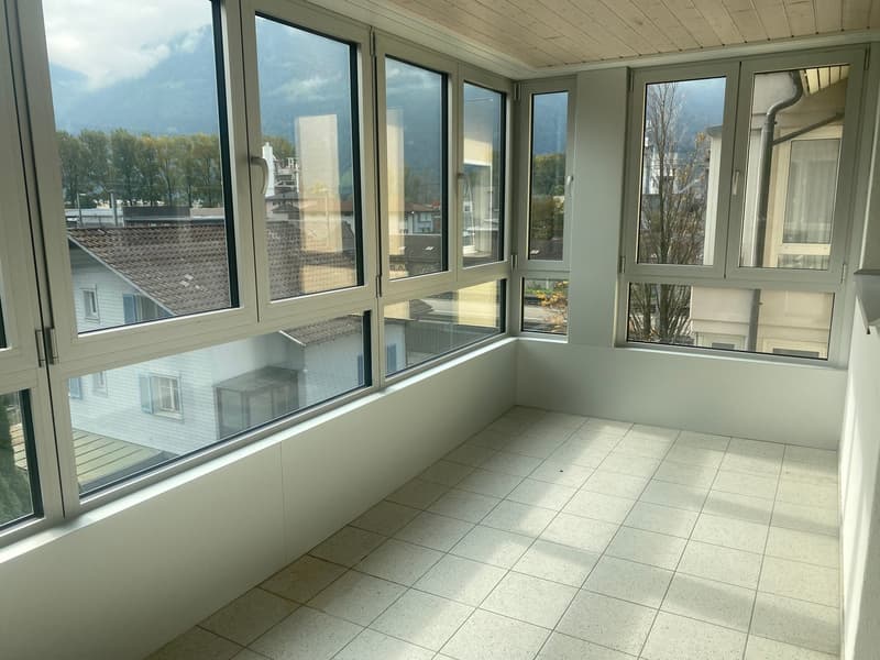 balcony, large windows, tiled floor, bright