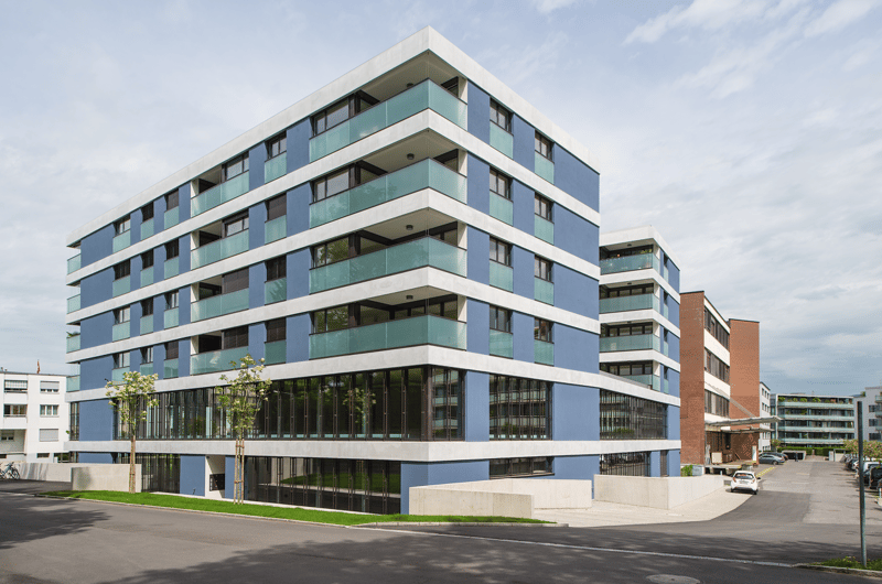 modern apartment building, blue and white facade, glass windows, balconies