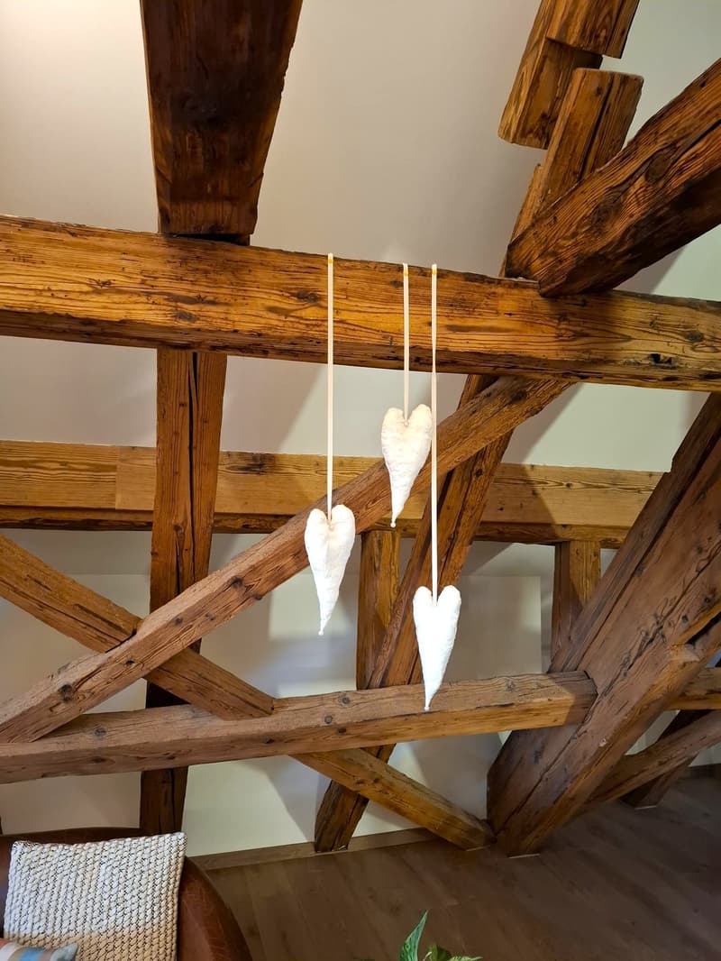 exposed wooden ceiling with heart shaped decorations